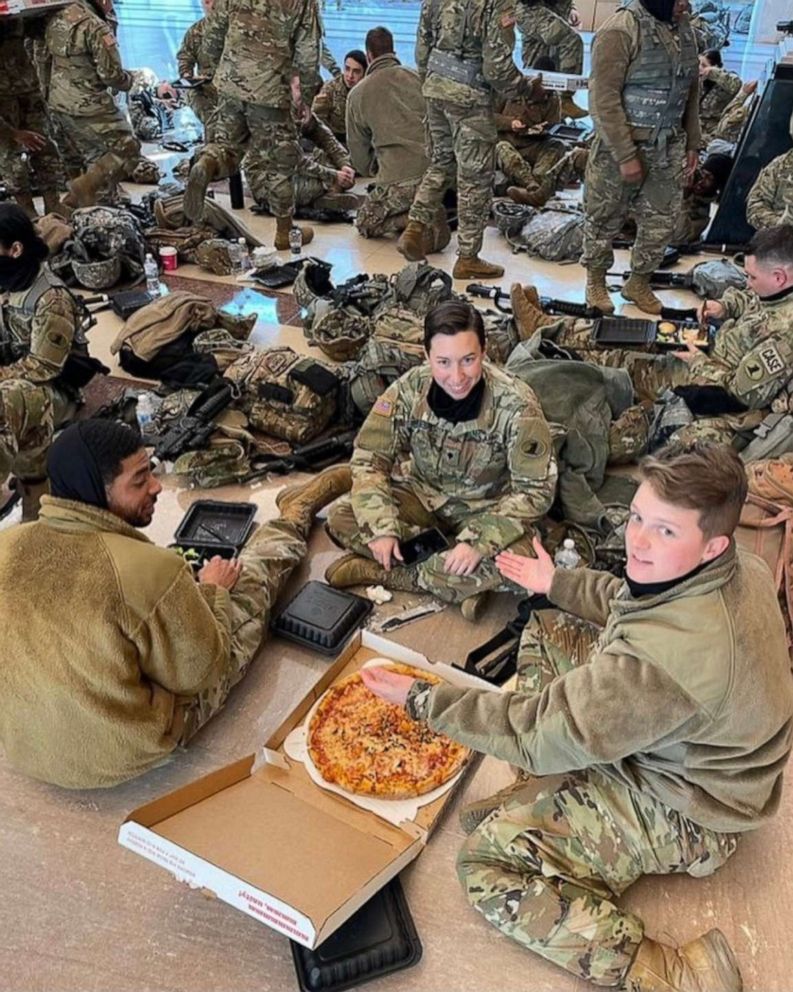 PHOTO: National Guard troops enjoy donated food from We, The Pizza while stationed inside the Capitol Building.