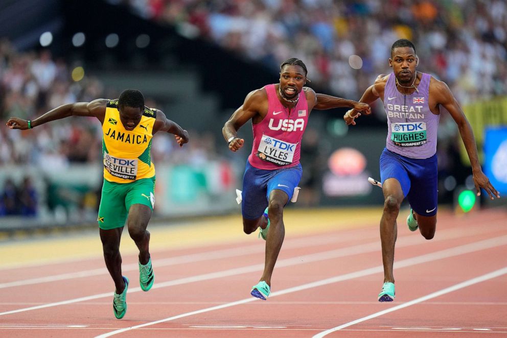 PHOTO: Noah Lyles, of the United States, center, crosses the line to win the gold medal in the men's 100-meters final during the World Athletics Championships in Budapest, Aug. 20, 2023.