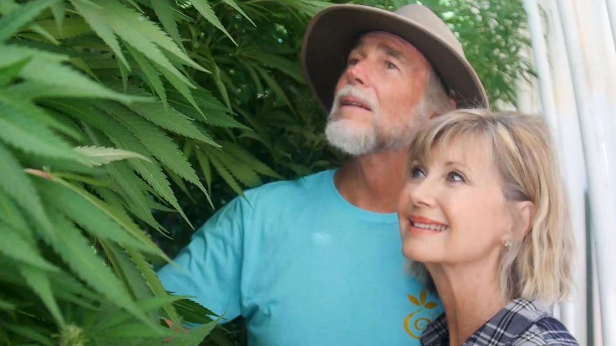 PHOTO: Olivia Newton-John is photographed with her husband John Easterling in their cannabis greenhouse at their California home.