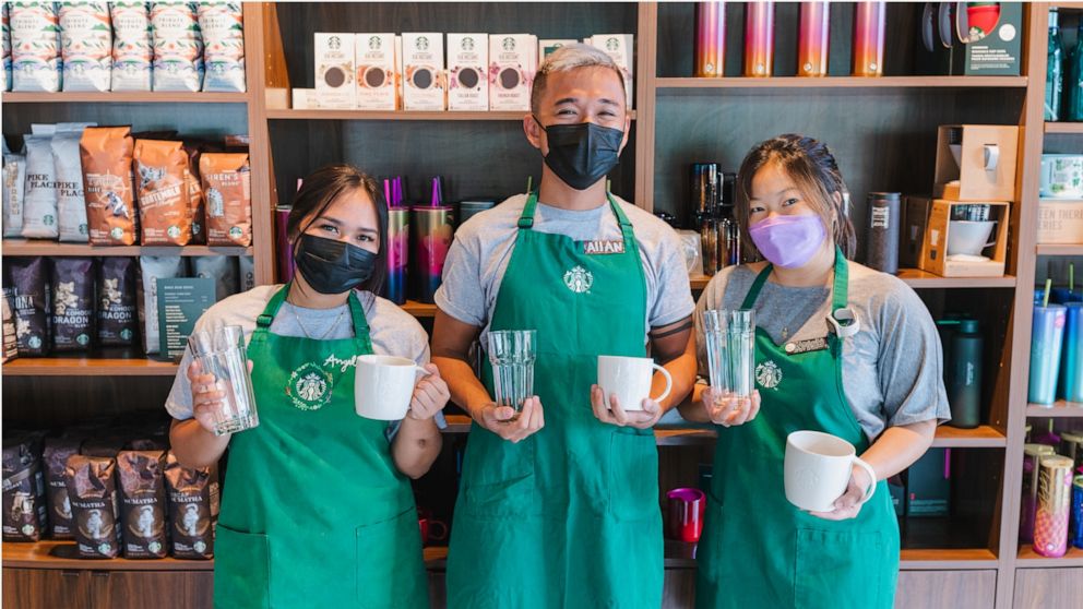 PHOTO: Starbucks employees who have piloted the reusable cups program.