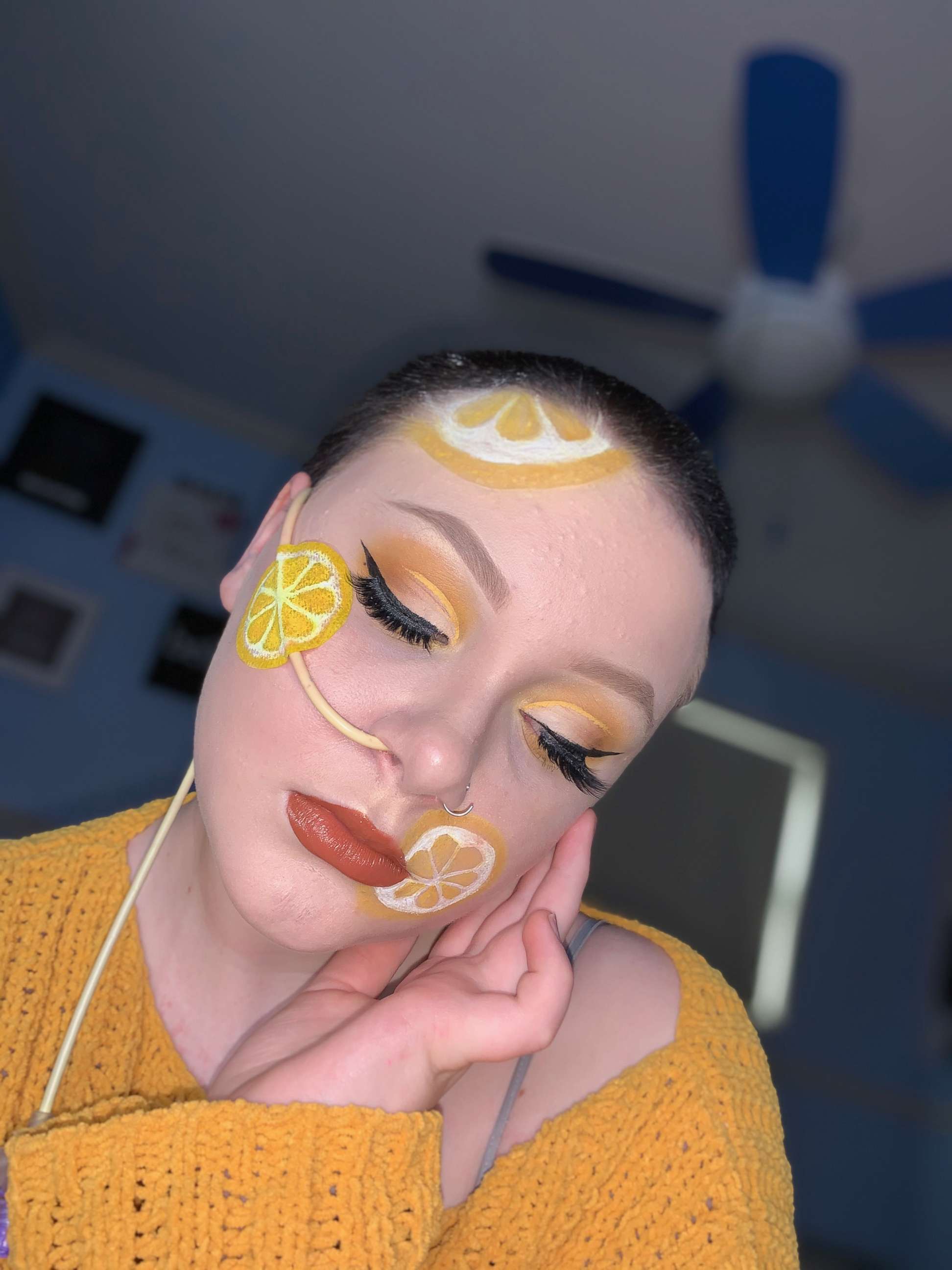 Olivia Finnegan modeling a yellow makeup look she created.