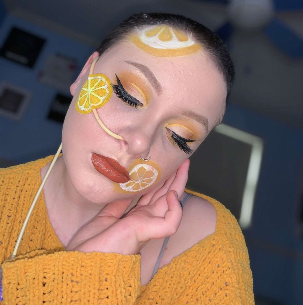 Olivia Finnegan modeling a yellow makeup look she created.