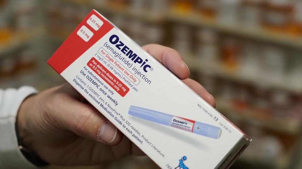 PHOTO: A pharmacist holds a box of Novo Nordisk A/S Ozempic brand semaglutide medication arranged at a pharmacy in Provo, Utah, Nov. 27, 2023.