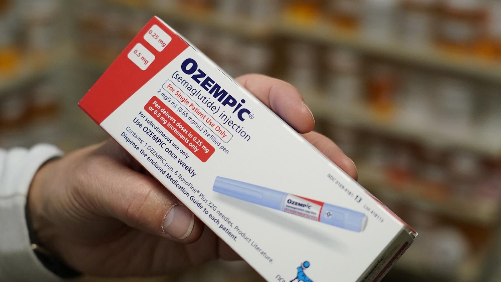 PHOTO: A pharmacist holds a box of Novo Nordisk A/S Ozempic brand semaglutide medication arranged at a pharmacy in Provo, Utah, Nov. 27, 2023.