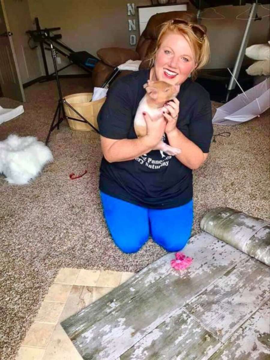PHOTO: Cashlie White holds a newborn piglet.