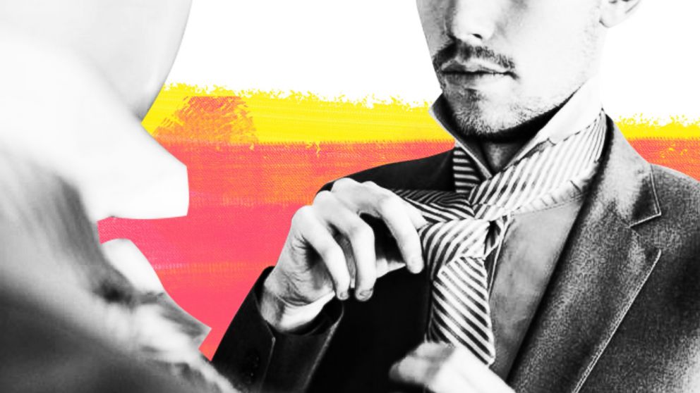 PHOTO: In this undated stock photo, a young businessman ties his tie in front of a mirror.