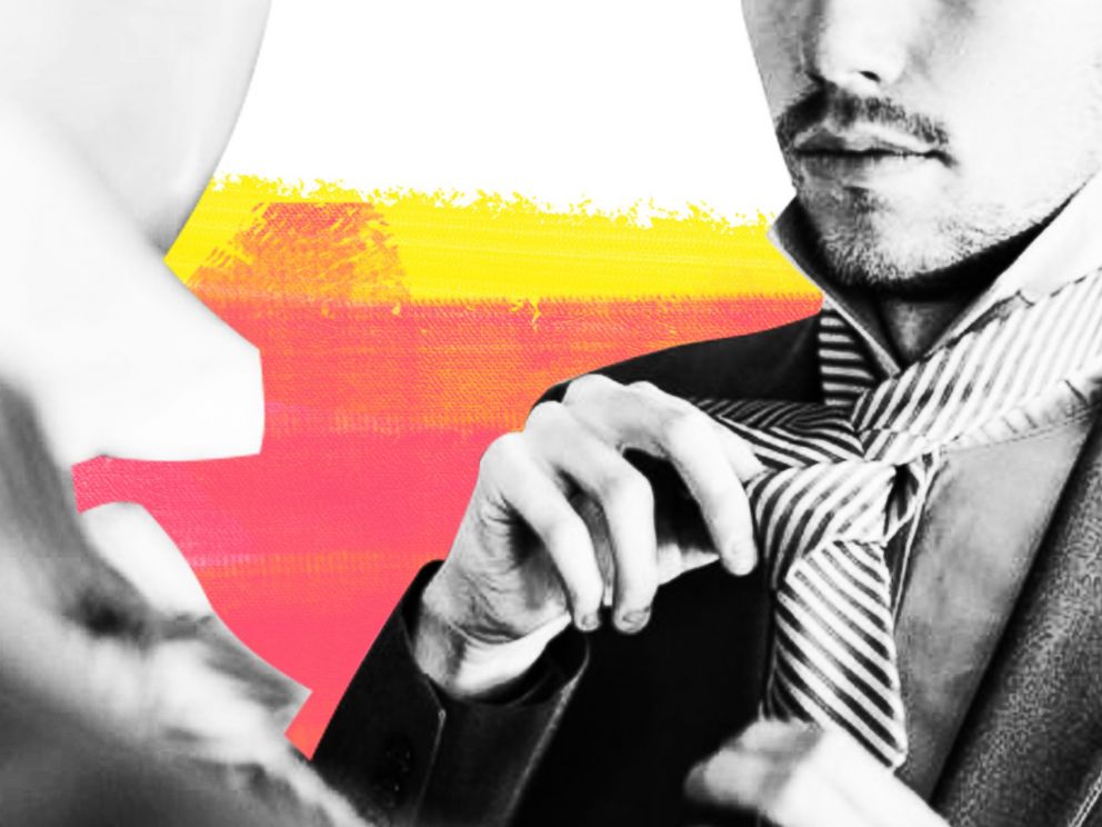 PHOTO: In this undated stock photo, a young businessman ties his tie in front of a mirror.