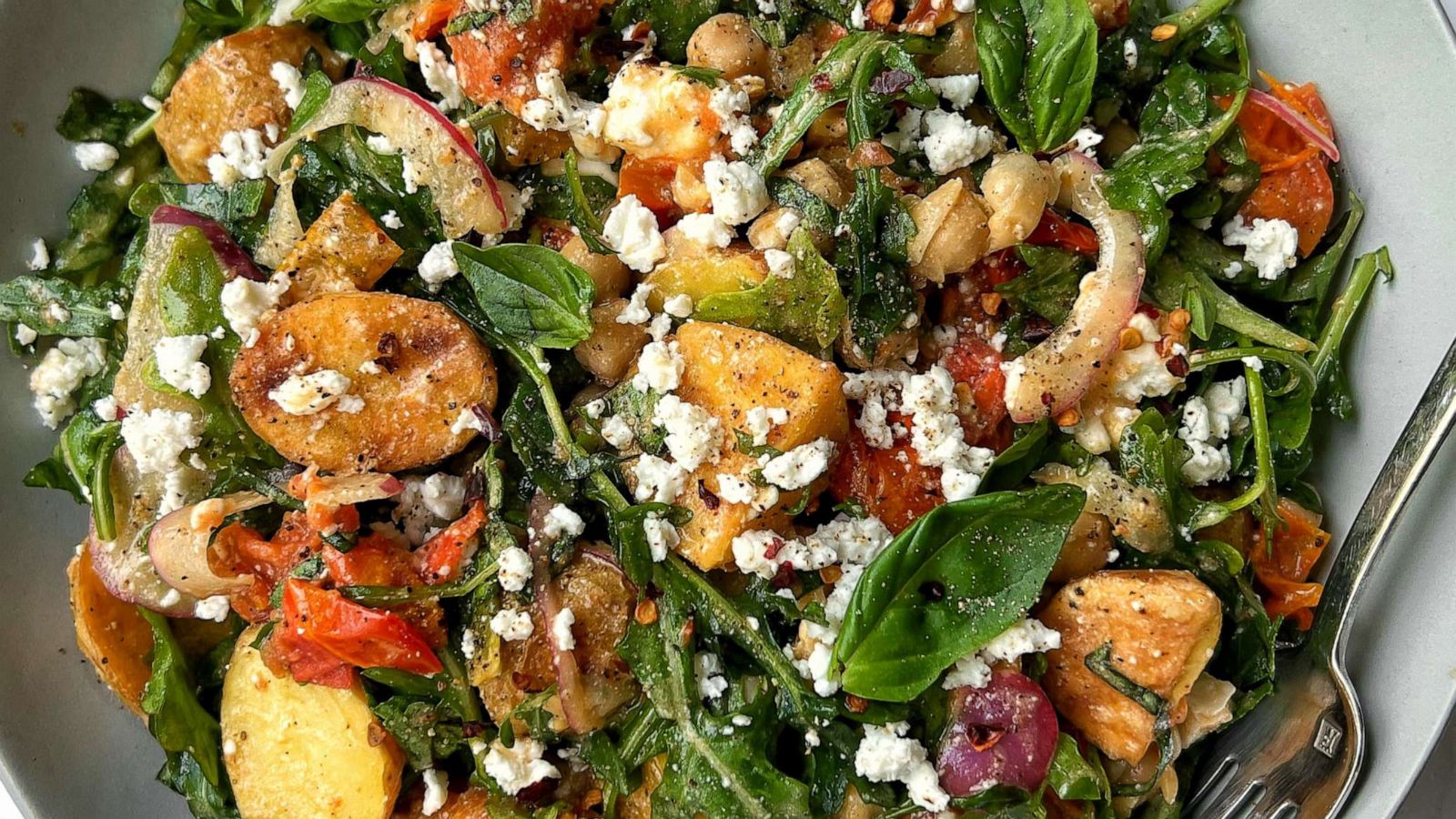 PHOTO: A potato and arugula salad with confit tomatoes.