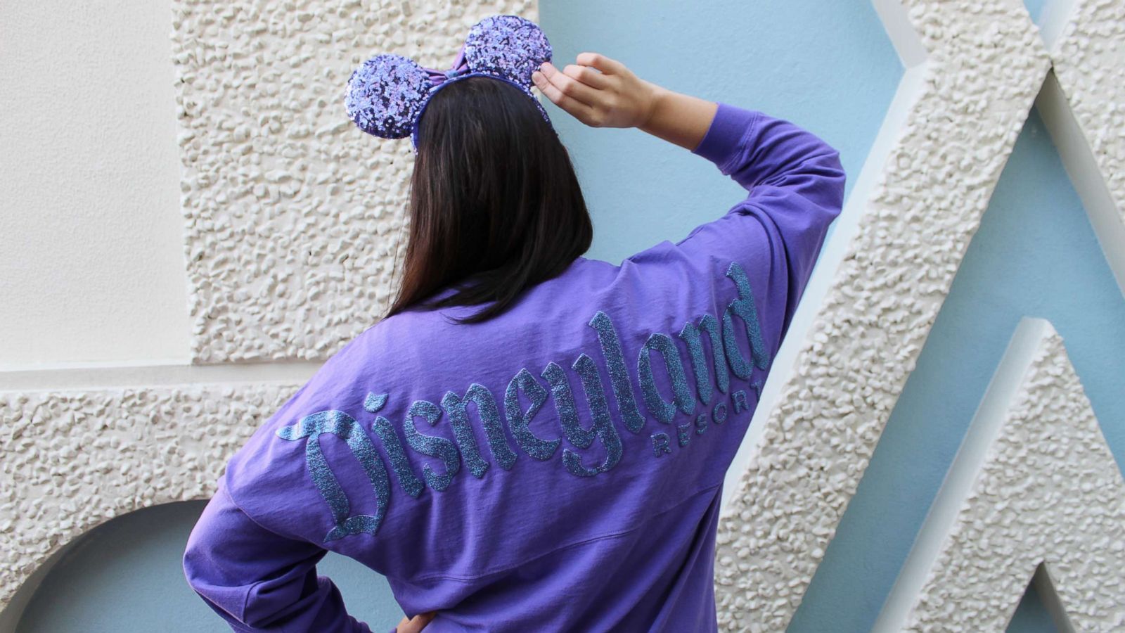 PHOTO: The Potion Purple Spirit Jersey features long sleeves and a shimmery resort logo with a “D” icon on the front while the back displays Disneyland Resort in its signature font.