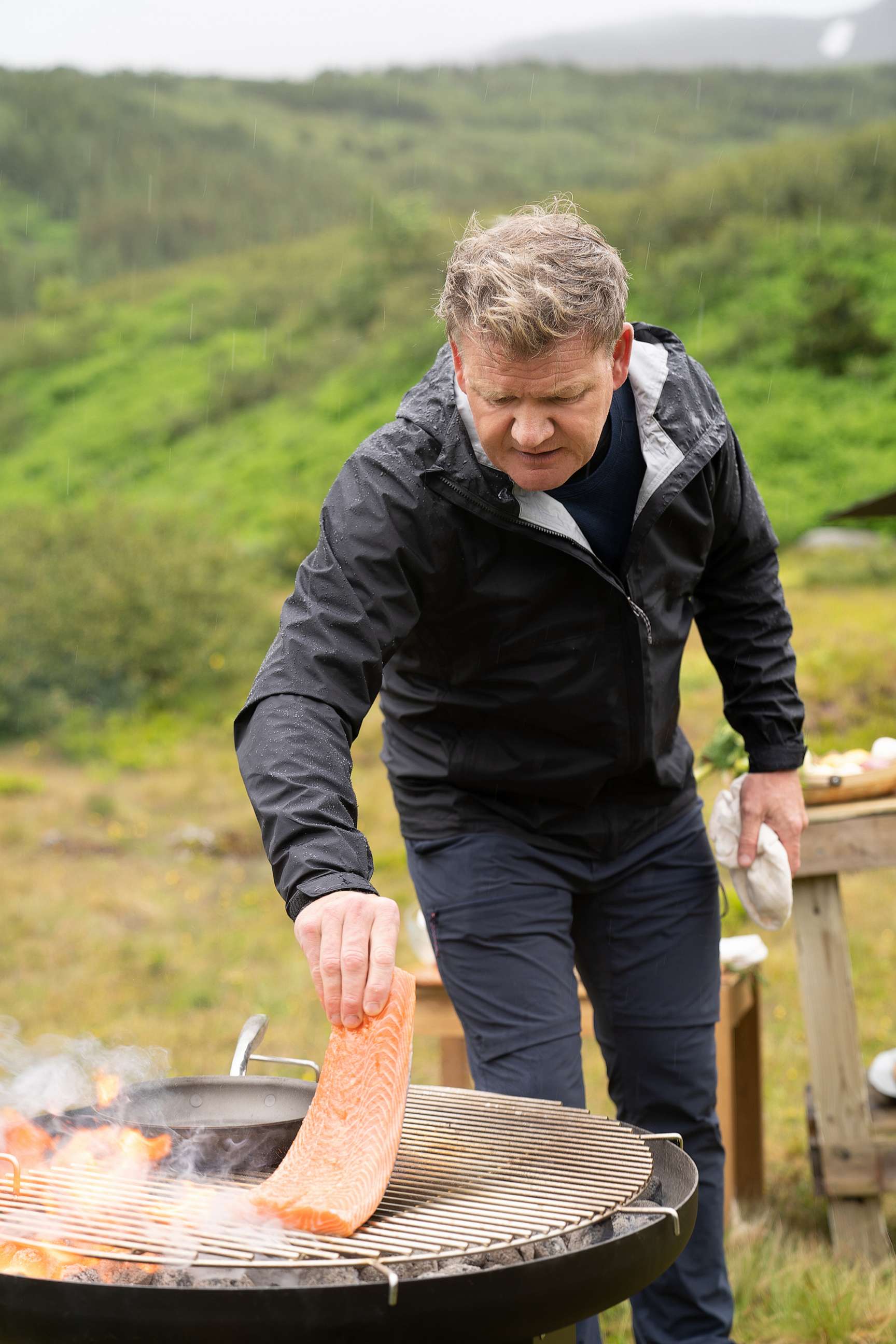 PHOTO: Rain falls as Gordon Ramsay grills fresh salmon during the final cook in Iceland.