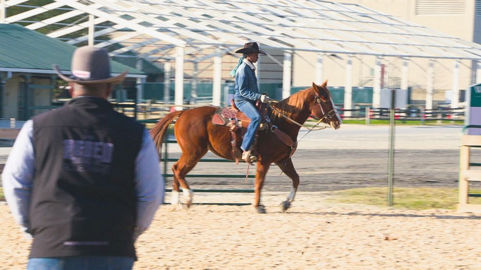 PHOTO: Corey Jackson watches Reagan Jackson train with horse Sunday.