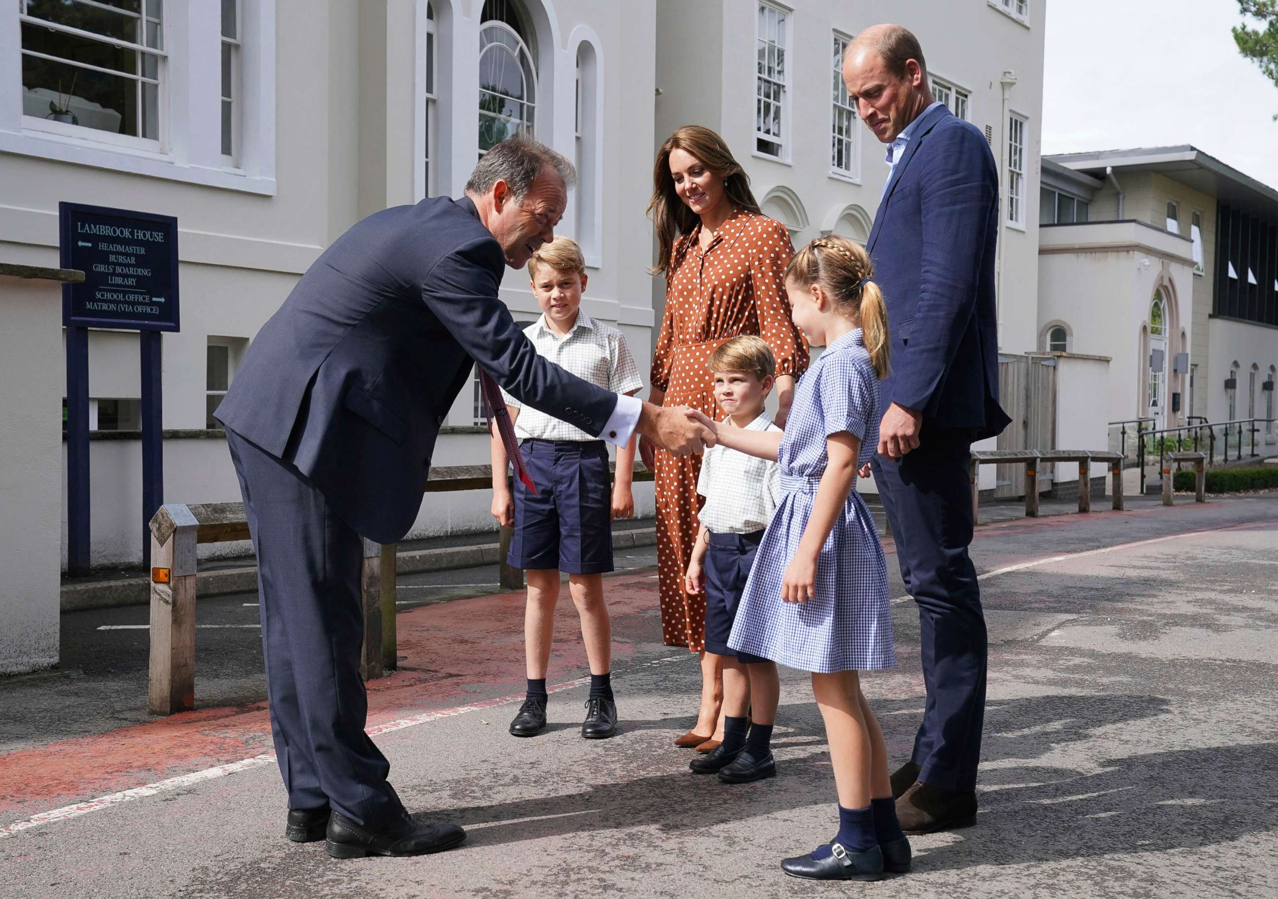 PHOTO: From second left, Britain's Prince George, Kate Duchess of Cambridge, Prince Louis, Prince William and Princess Charlotte are greeted by Headmaster Jonathan Perry, left, at Lambrook School, near Ascot, England, Sept. 7, 2022. 