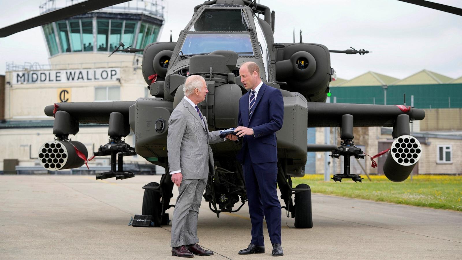 PHOTO: Britain's King Charles III officially hands over the role of Colonel-in-Chief of the Army Air Corps to Britain's Prince William in front of an Apache helicopter in Middle Wallop, England, on May 13, 2024.