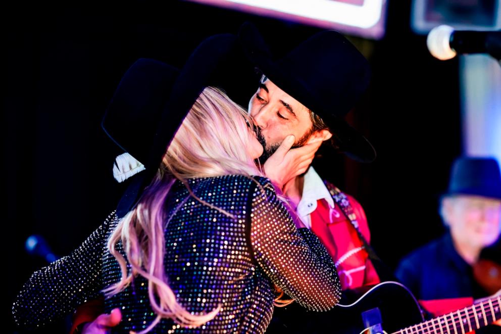 PHOTO: Hassie Harrison and Ryan Bingham on stage at the Bingham's Bourbon NFR After Party in Las Vegas, NV, Dec. 7, 2023. 