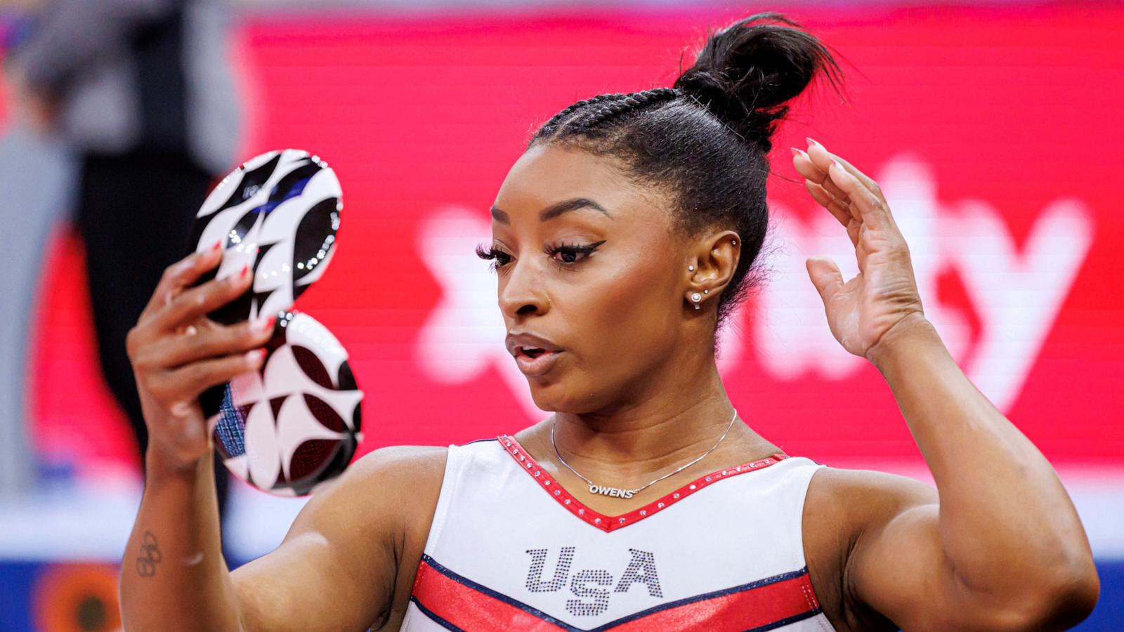 PHOTO: Simone Biles looks at herself in a mirror during the Women's Day Four of 2024 US Olympic Gymnastics Trials at the Target Center in Minneapolis, MN, June 30, 2024.