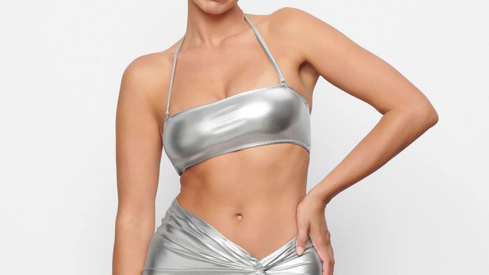See Kim Kardashian Model the Skims Metallic Swim Collection