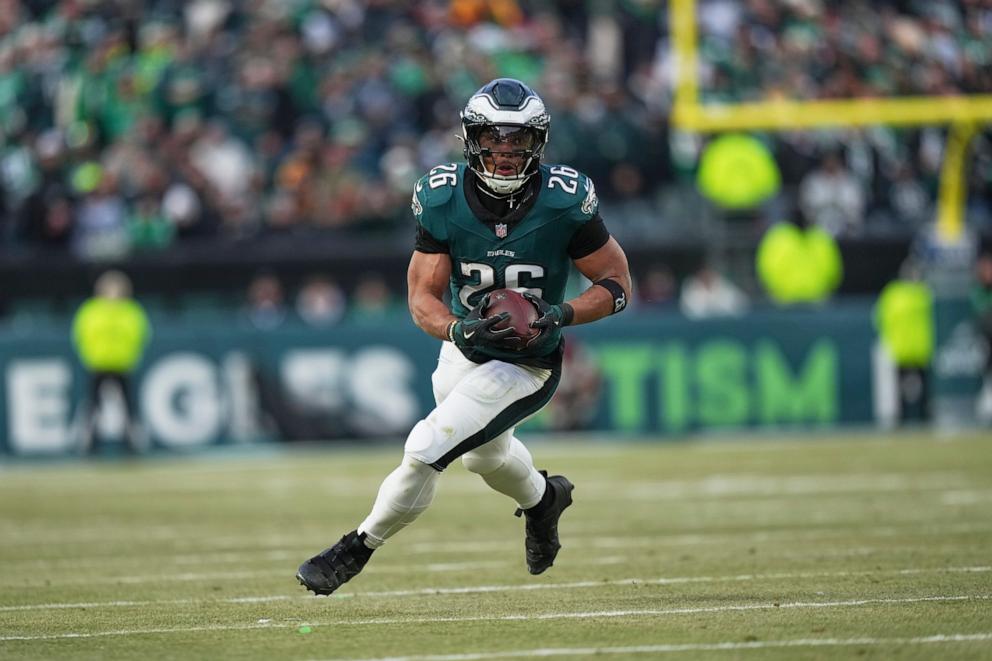 PHOTO: Philadelphia Eagles running back Saquon Barkley rushes for a gain against the Washington Commanders during the first half of the NFC Championship NFL football game, Jan. 26, 2025, in Philadelphia. 