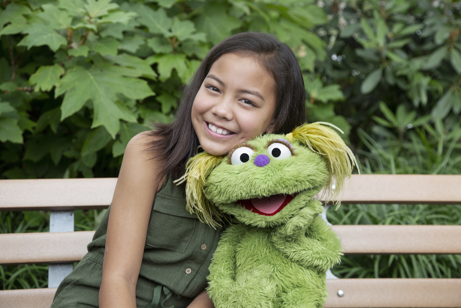 PHOTO: Salia Woodbury, whose parents are in recovery sits with "Sesame Street" character Karli.