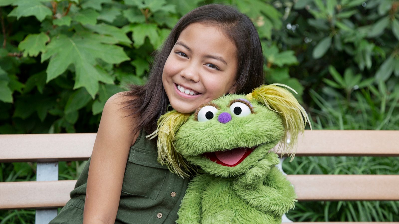 PHOTO: Salia Woodbury, whose parents are in recovery sits with "Sesame Street" character Karli.