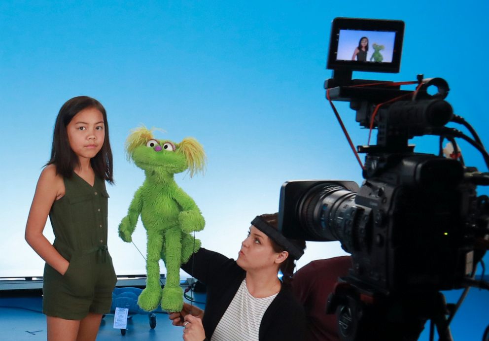 PHOTO: Salia Woodbury, 10, left, from Irvine, Calif., on the set with "Sesame Street"  muppet Karli and puppeteer Haley Jenkins during a taping about parental addiction in New York.