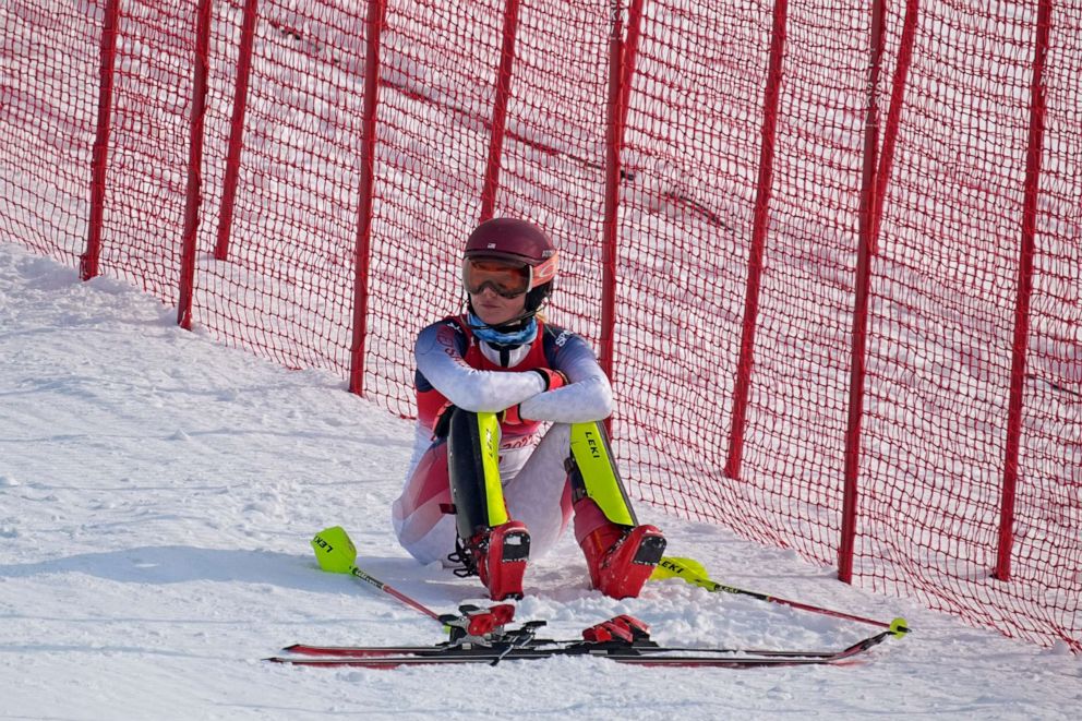PHOTO: Mikaela Shiffrin, of the United States sits on the side of the course after skiing out in the first run of the women's slalom at the 2022 Winter Olympics, Feb. 9, 2022, in the Yanqing district of Beijing.
