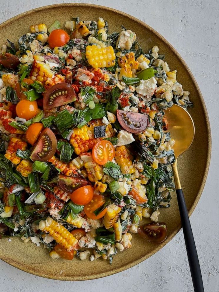 PHOTO: A bowl of smoky corn salad with tomatoes and herbs.