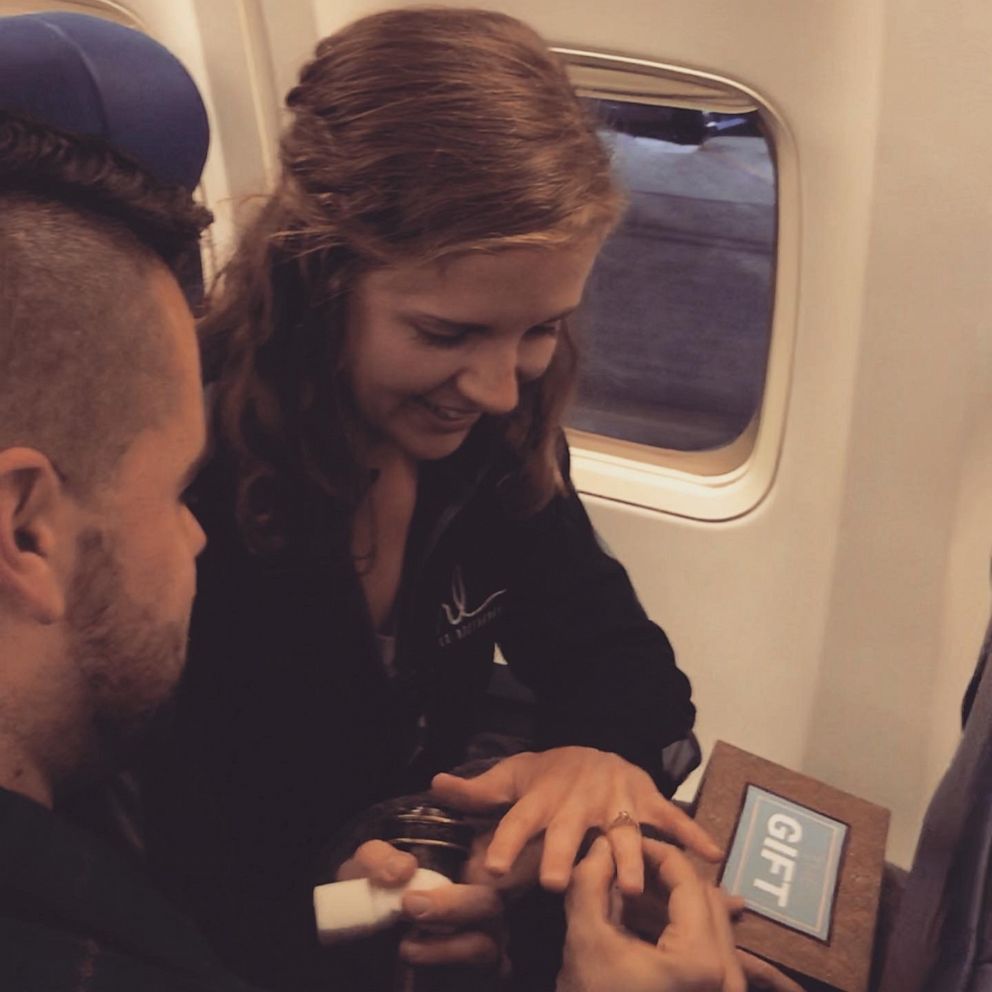 PHOTO: Woman shocked when boyfriend surprises her on flight and proposes