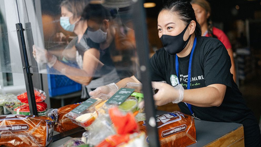 PHOTO: A Starbucks employee works to gather food to be donated. 