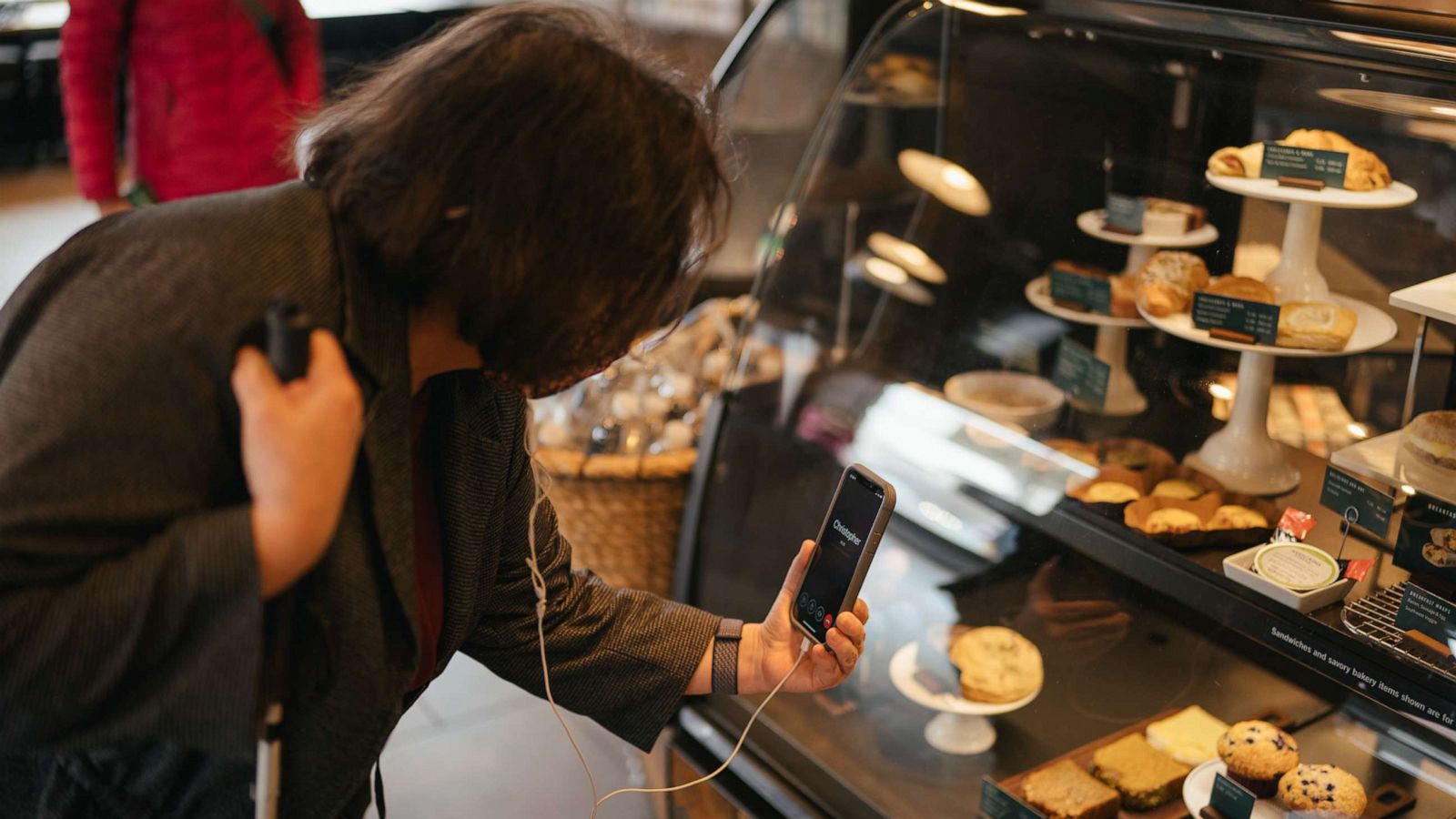 PHOTO: A woman uses Aira technology services to navigate Starbucks.