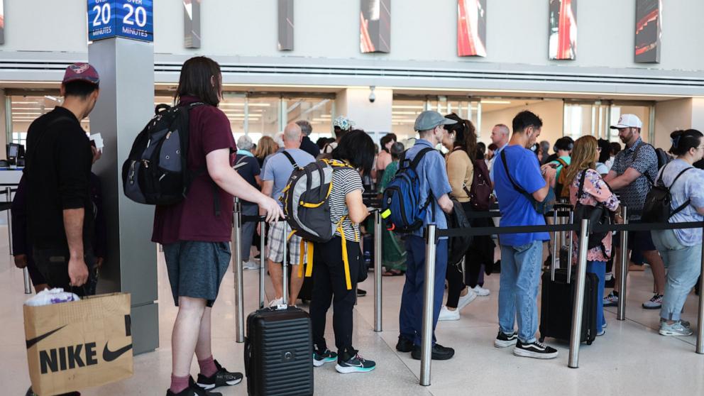 PHOTO: Passengers arrive at security gates of La Guardia airport during Memorial weekend in the Queens borough of New York City, May 24, 2024. 