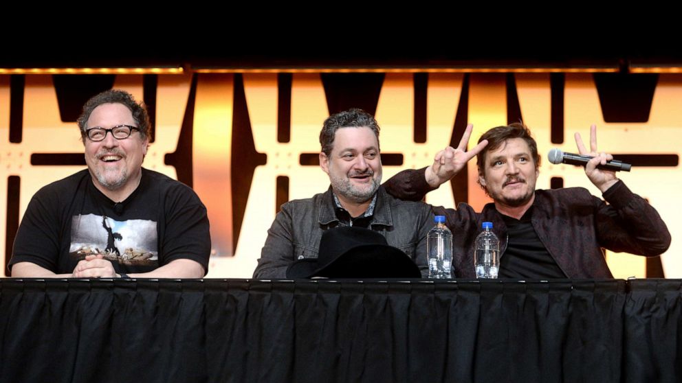 PHOTO: Writer/executive producer Jon Favreau, Director/executive producer Dave Filoni and Pedro Pascal onstage during "The Mandalorian" panel at the Star Wars Celebration at McCormick Place Convention Center, April 14, 2019, in Chicago.