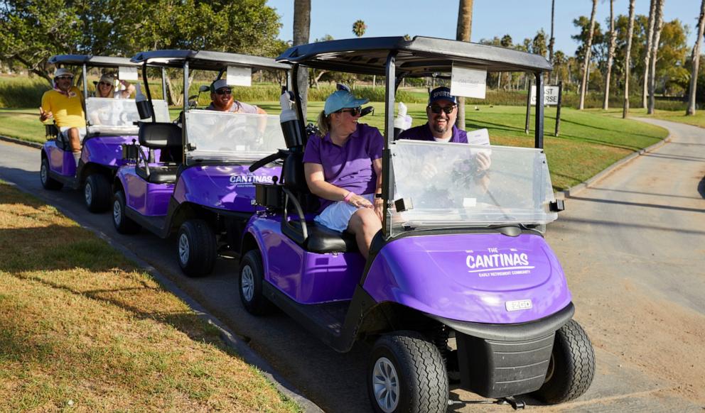 PHOTO: A group of Taco Bell fans hit the golf course in custom purple golf carts at The Cantinas pop-up.