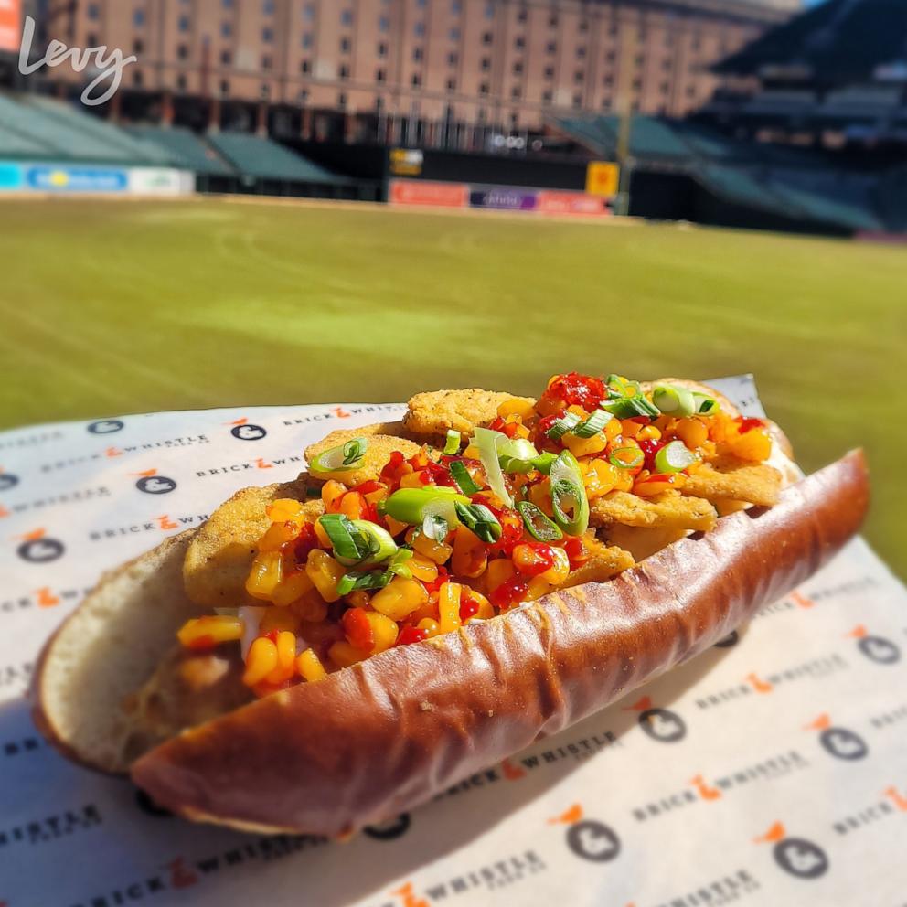 PHOTO: The Chessie, a footlong Chesapeake sausage smothered with creamy crab dip, pickled sweet corn, and fried green tomatoes, served on a soft pretzel bun.