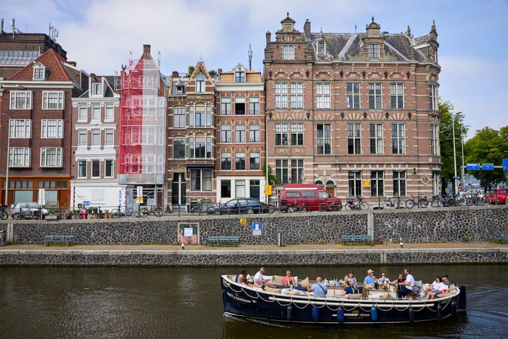 PHOTO: A tourist sightseeing boat navigating a canal in Amsterdam, Netherlands, Aug. 18, 2023. 