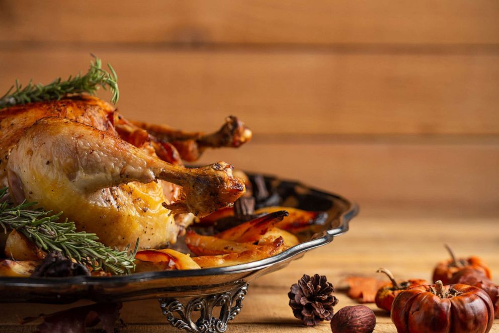 PHOTO: A roasted turkey leg with mushrooms and baked potatoes is served for Thanksgiving dinner.