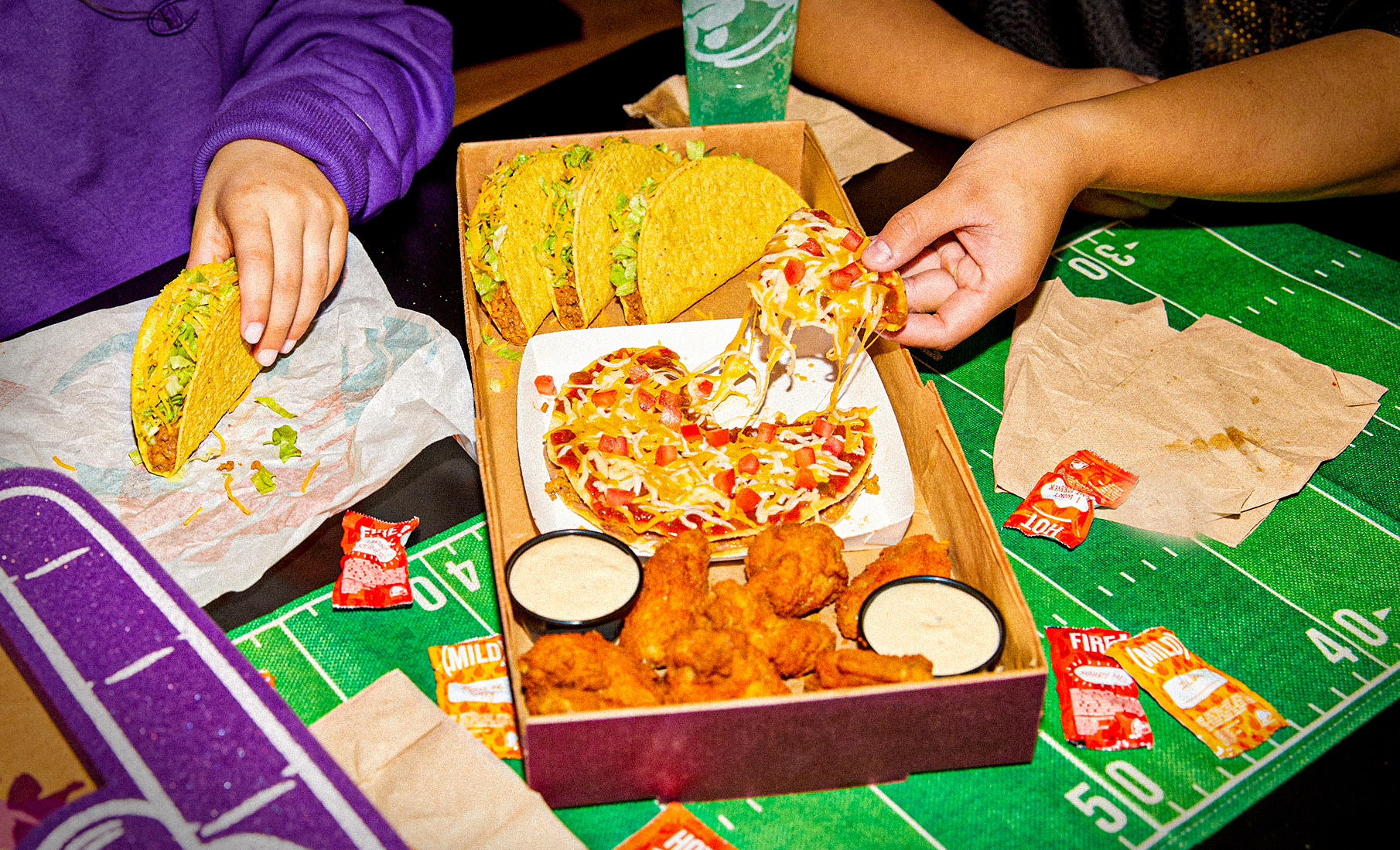 PHOTO: The Ultimate Game Day Box at taco bell with chicken wings, Mexican pizza and crunchy tacos.