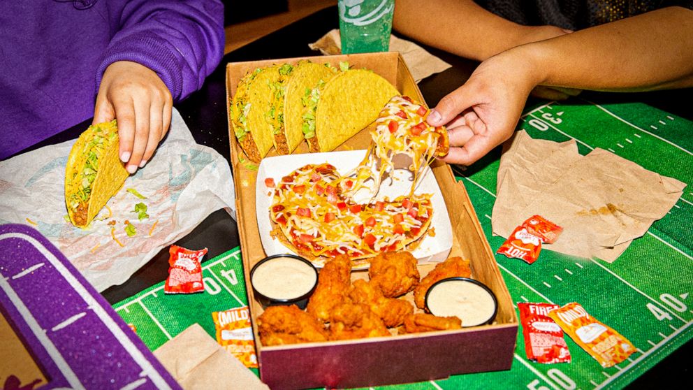 PHOTO: The Ultimate Game Day Box at taco bell with chicken wings, Mexican pizza and crunchy tacos.