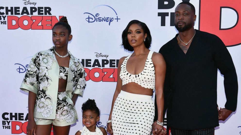 PHOTO: Gabrielle Union (2R) and Dwayne Wade pose with daughters Zaya Wade (L) and Kaavia James Union Wade (2L) as they arrive for the "Cheaper by the Dozen" Disney premiere at the El Capitan theatre in Hollywood, Calif., March 16, 2022.