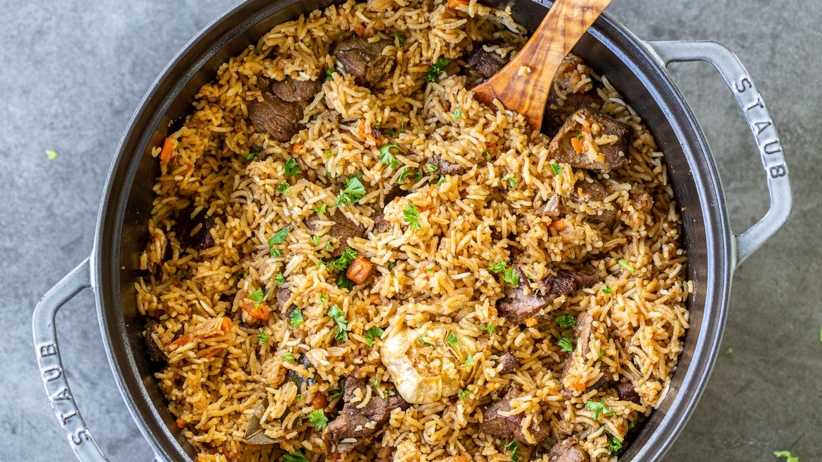 PHOTO: Uzbek Plov is a rice pilaf and braised lamb dish that comes together in a cast-iron Dutch oven.