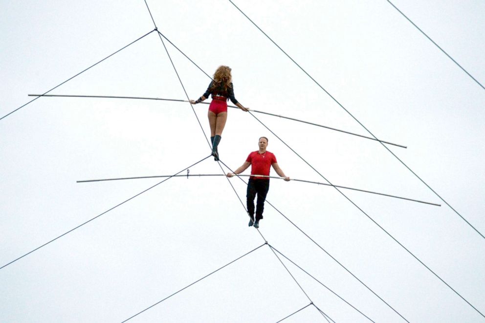 PHOTO:Nik Wallenda, right, walks the tightrope above Charlotte Motor Speedway, October 12, 2013, with his sister, Lijana, 140 feet above pit road during the pre-race show at the Bank of America 500 NASCAR Sprint Cup race in Charlotte, N.C.