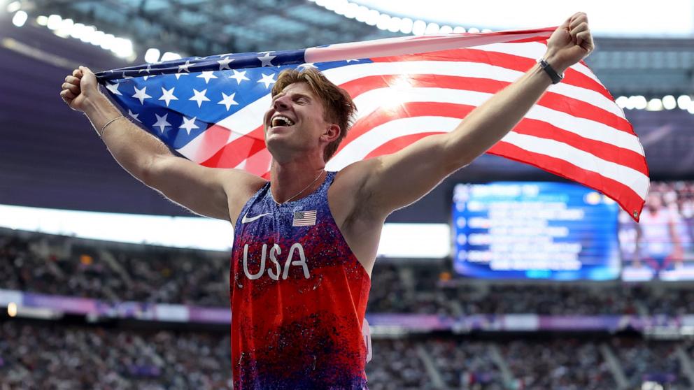 PHOTO: Hunter Woodhall celebrates with the flag of United States after winning a gold medal in the Men's Para Athletics 400m T62 Final Race on day nine of the Paris 2024 Summer Paralympic Games at Stade de France on Sept. 6, 2024 in Paris.