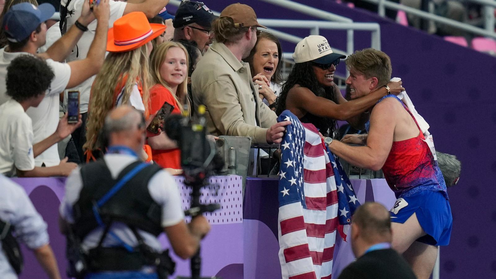 PHOTO: Hunter Woodhall hugs his wife Tara Davis-Woodhall who won the gold medal during Paris 2024 Olympics in Women's Long Jump, after winning himself the men's 400 m. T62 final at the 2024 Paralympics, Sept. 6, 2024, in Paris.