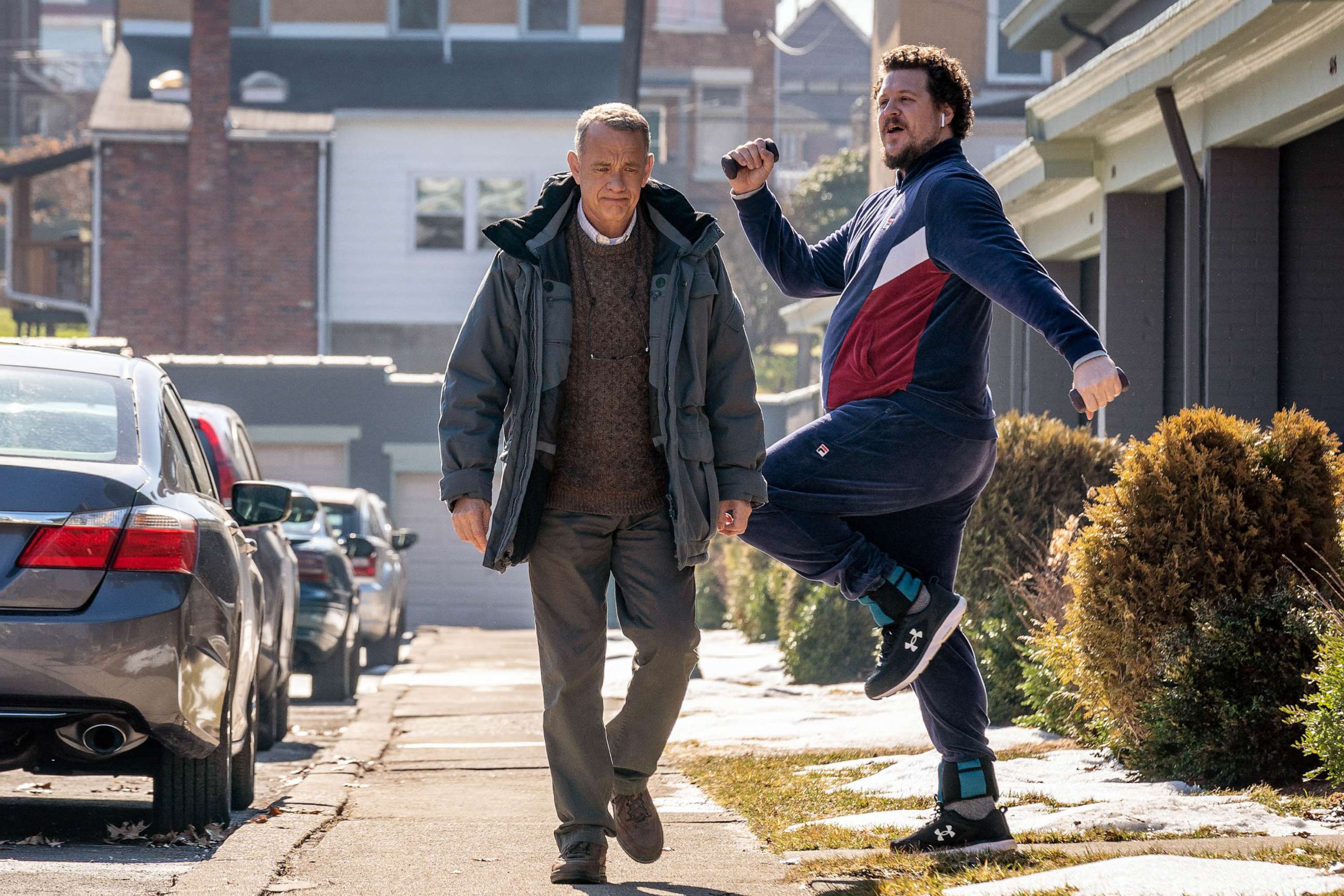 PHOTO: Jimmy, played by Cameron Britton, jogs by Otto, played by Tom Hanks, in Columbia Pictures' "A Man Called Otto."
