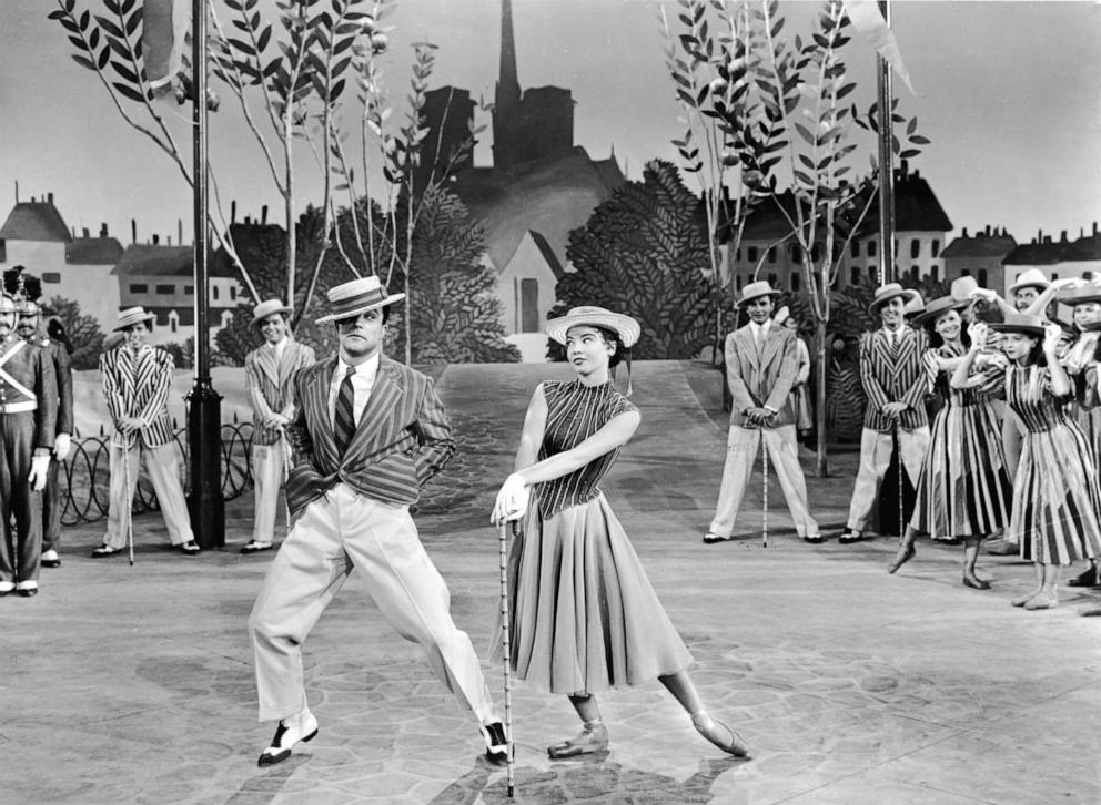 PHOTO: Gene Kelly dances next to Leslie Caron a in a still from the 1951 film "An American In Paris." 
