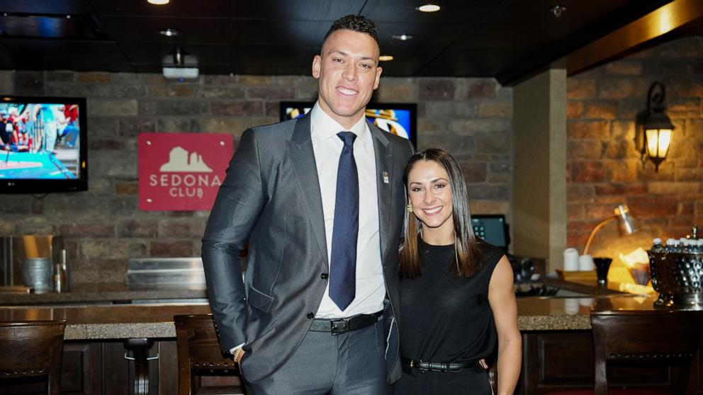 PHOTO: Aaron Judge of the New York Yankees and his wife, Samantha Bracksieck, pose for a photo during a Make-A-Wish foundation meet and greet at the 2023 World Series between the Texas Rangers and the Arizona Diamondbacks in Phoenix, Ariz., Oct. 30, 2023.