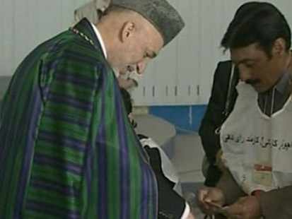 VIDEO: The Afghan president caves to international pressure for a runoff election.