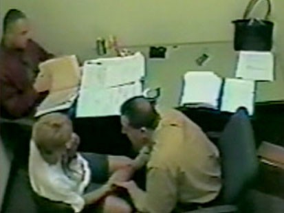 A picture of Casey Anthonys mother being interrogated by police.