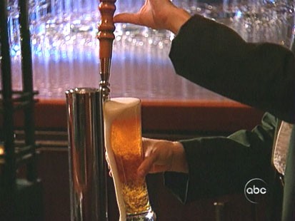 A picture of some one pouring a beer.