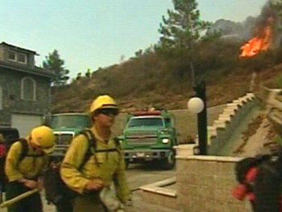 VIDEO: Firefighters try to beat back the flames threatening thousands of homes.