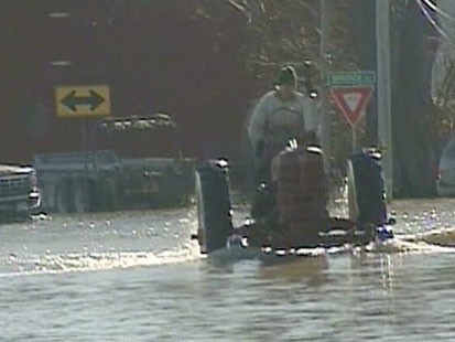 VIDEO: A tractor driving through a flooded street.
